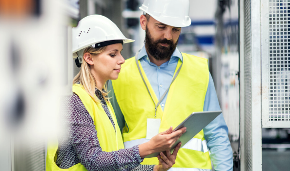 Man and woman in high viz and hard hat