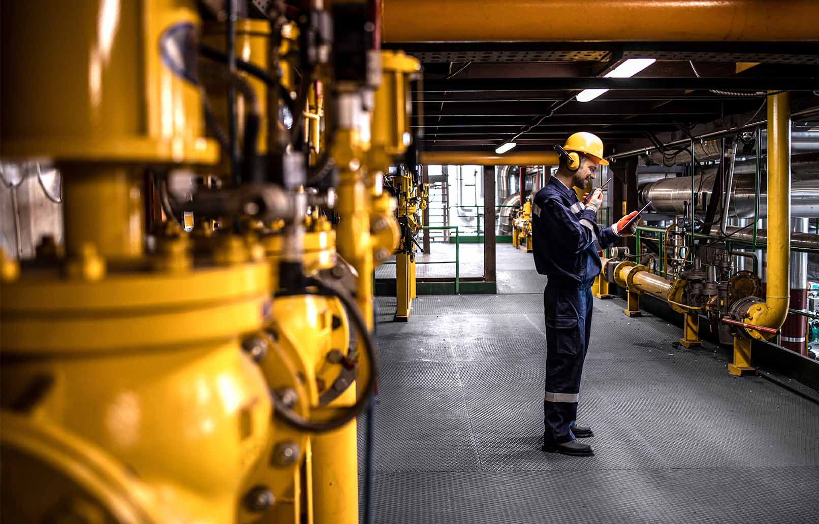 person looking at tablet in petrochemical industry